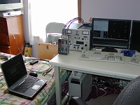  This is the equipment necessary for a beam steering receiving system.  The system consists of the computer below the table, keyboard and monitor, the laptop to control the DDS-60 local oscillator, and the 4 Softrock v6 receivers in the metal box.  The service monitor is for testing.